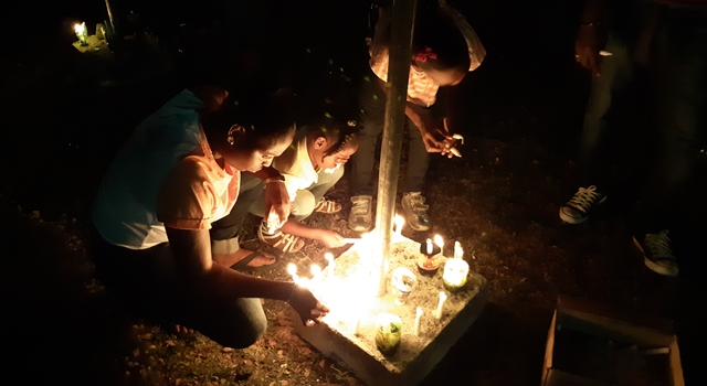 Mourners lit candles at vigil for Rudyard 'Kippy' Mears. (OH News Photo)
