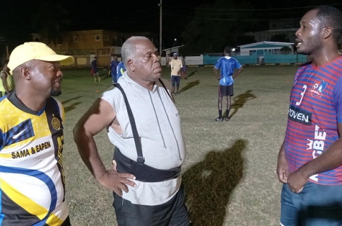 Coaches Jermaine Douglas (left) and Bill Martin (centre) locked in a conversation with Andre Dyce during training at the Old Harbour Glades Community Playfield. (OH News Photo)