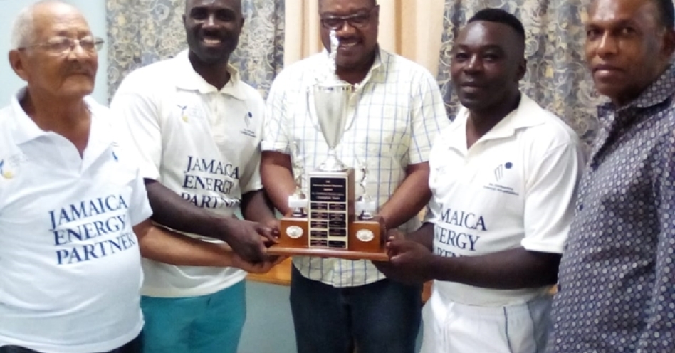 Jamaica Cricket Association chief executive officer Courtney Francis (centre) presents the champions trophy to Innswood Old Boys skipper Kirk Gordon (2nd right) and Basement caption Akbar Moodie (2nd left). Sharing in the presentation are Jamaica Cricket Association president Wilford ‘Billy’ Heaven (right) and St Catherine Cricket Association life member David Miranda.