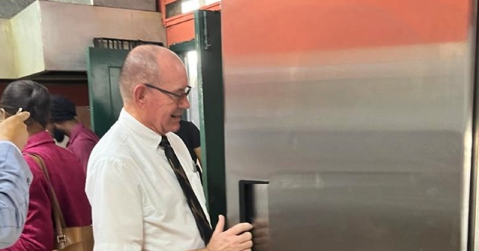 Chris Sexton, missionary of the Church of Jesus Christ of Latter-day Saints inspects one of the standing deep freezers donated to the Greater Portmore Primary School recently.