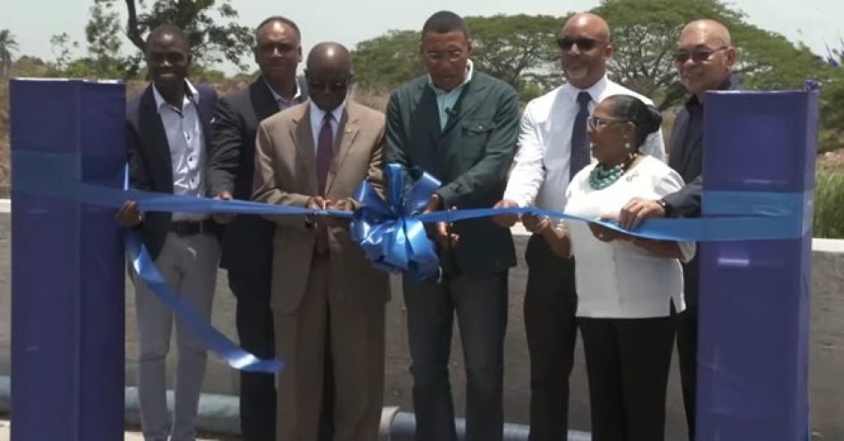Prime Minister Dr Andrew Holness (centre) and Member of Parliament Everald Warmington lead the symbolic ribbing cutting exercise marking the formal handover of the Myton Gully bridge on June 10, 2025.