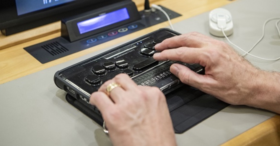 A participant using his Braille display at an event for the International Day of Persons with Disabilities. (Image Credit: UN)